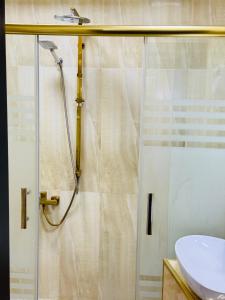 a bathroom with a shower and a sink at Bəy Hotel Baku in Baku