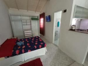a small bedroom with a bed and a bathroom at Residencial Garcia Diárias Econômicas in Florianópolis