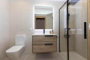 a bathroom with a toilet and a sink and a shower at Sueños del Garmo by BeValle in Panticosa