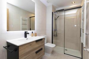 a bathroom with a sink and a toilet and a shower at Sueños del Garmo by BeValle in Panticosa