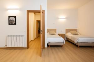 a room with two beds and a door to a bedroom at Sueños del Garmo by BeValle in Panticosa +23 photos
