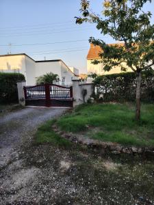 a fence in front of a house with a yard at Chez Pam et David in Saint-Maixent-lʼÉcole