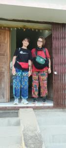 two people standing in a doorway of a building at Budha ashram guest house in Bodh Gaya