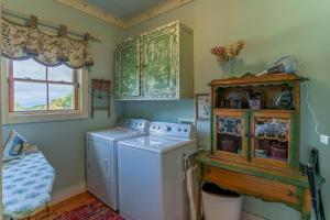 a laundry room with a washing machine and a window at D-Coys Nest in Banner Elk +53 photos