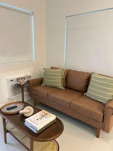 a living room with a couch and a coffee table at Chic Modern Studio with Queen Bed in Fort Lauderdale