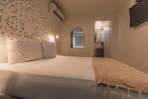 Postel nebo postele na pokoji v ubytování Ataraxy Hotel Boutique