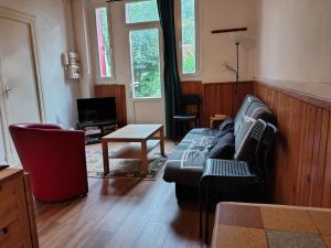 a living room with a couch and a table at Villa Marguerite in Ax-les-Thermes