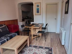 a living room with a table and a couch at Villa Marguerite in Ax-les-Thermes