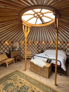 a bedroom with a bed in a yurt at The Isla Yurt in Colchester