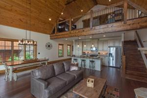 a large living room with a couch and a kitchen at Peregrine's Perch at Eagles Nest in Elk Park
