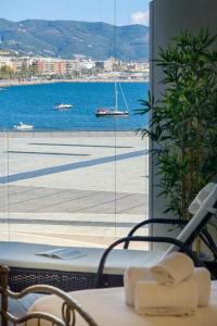 a bathroom with a view of the water and a window at Crescent Luxury Retreat - Seafront Apartments in Salerno