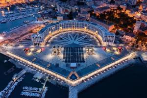 an aerial view of a casino at night at Crescent Luxury Retreat - Seafront Apartments in Salerno +94 photos