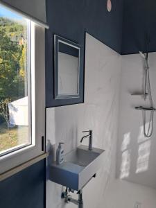 a bathroom with a sink and a window at Gino's House in Gubbio