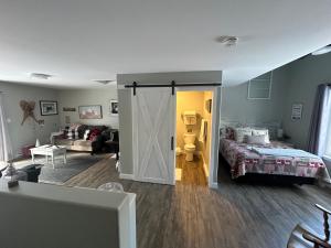 a bedroom with a bed and a sliding door at The Klinck House in Collingwood
