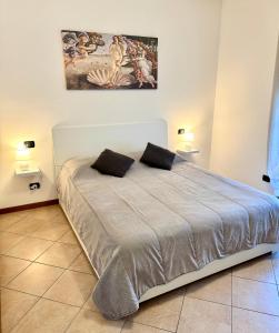 a bedroom with a bed with two pillows on it at Top Apartment 2 in Castel d'Azzano