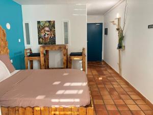 a bedroom with a bed and a room with a hallway at Cosy Studio in La Trinité