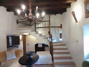 a living room with a staircase with a chandelier at Il Castello della Dama in Bassano in Teverina