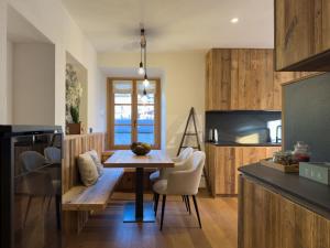a kitchen with a table and chairs in a room at La Torrina in Bormio