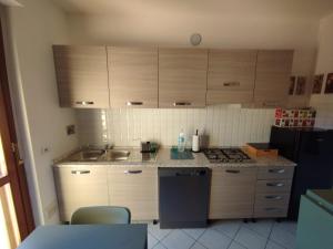 eine Küche mit Spüle, Herd und Schränken in der Unterkunft Book Nook Pisa, circa 10 minuti da Pisa, vicino all'Ospedale di Cisanello e all'Aeroporto, parcheggio privato a disposizione in Cascina