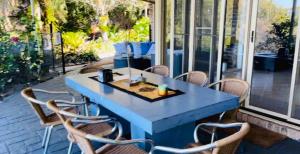 a blue table and chairs on a patio at Como Guest Suite - Pet Friendly in Gold Coast