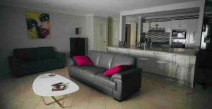 a living room with a couch and a table at Como Guest Suite - Pet Friendly in Gold Coast