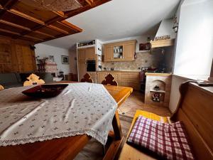 a kitchen with a wooden table and a dining room at Appartamento Town Center in Predazzo