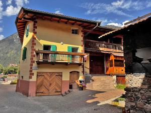 a house with a balcony on the side of it at Appartamento Town Center in Predazzo
