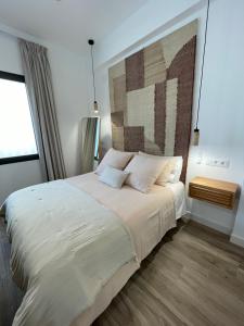 En eller flere senge i et værelse på Apartamento Isla Cristina