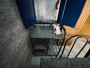 a bathroom with a counter and a chair in a room at Charming Bahia House in Pelourinho in Salvador