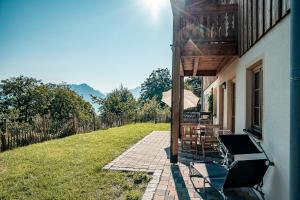 a patio with a table and chairs and an umbrella at Schoberhof in Samerberg