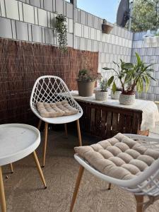 a patio with two chairs and a table with plants at Modernes Apartment - Kirchfeld in Karlsruhe