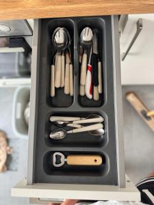 a black container with utensils in a drawer at Modernes Apartment - Kirchfeld in Karlsruhe