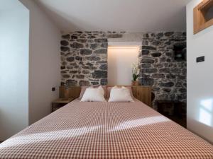 a bedroom with a large bed with two pillows at La Torrina in Bormio