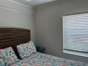 a bedroom with a bed with a window and a pillow at Gulf Front Cottages in Englewood