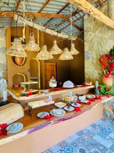 a kitchen with a table with plates of food at Quinta dos Laranjais Chalés in Viçosa do Ceará +178 photos
