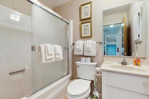 a bathroom with a toilet and a shower and a sink at Katherine Court Townhouse in Stateline +15 photos