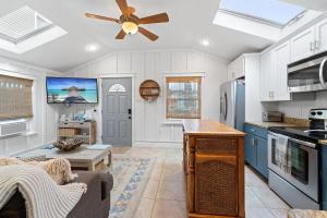 a kitchen with blue cabinets and a ceiling fan at Margate Home w/ Large Outdoor Kitchen in Margate City