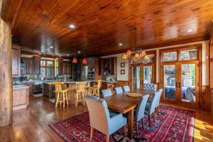 a kitchen and dining room with a wooden table and chairs at Overlook Estate in The Farm in Banner Elk
