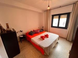 a bedroom with a bed with two teddy bears on it at La Casa del Musico 1 in Almería