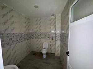 a bathroom with a toilet and a shower at Appartement 135m new and furnished very good looking in Oujda