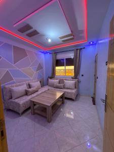 a living room with a couch and a table at Appartement 135m new and furnished very good looking in Oujda