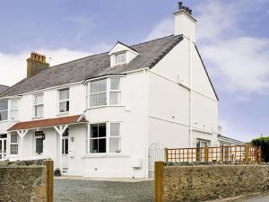 a white house with a black roof at West View in Rhosneigr