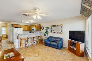a living room with a ceiling fan and a kitchen at Water Wheel Resort Condo G202 in New Braunfels