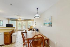 a kitchen and dining room with a table and chairs at Water Wheel Resort Condo G202 in New Braunfels