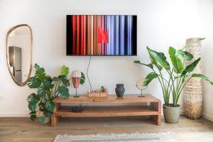 ein Wohnzimmer mit einem Couchtisch und Pflanzen in der Unterkunft Appartement F3 Neuf Vue sur la Seine avec Parking Gratuit Proche Paris Tour Eiffel & Disney in Cormeilles-en-Parisis