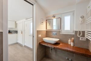 a bathroom with a white sink on a counter at Boutique Suites 186 in Sorrento +106 photos