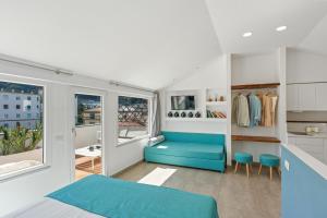 a bedroom with a blue bed and a window at Boutique Suites 186 in Sorrento