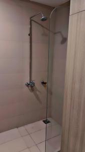 a shower with a glass door in a bathroom at JW Apartments in Dargai +20 photos