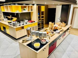 a kitchen with a large island with food on it at ibis Budget Clermont Ferrand Centre Montferrand in Clermont-Ferrand