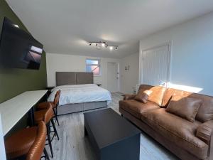 a living room with a bed and a couch at Little studio flat in Southgate +9 photos